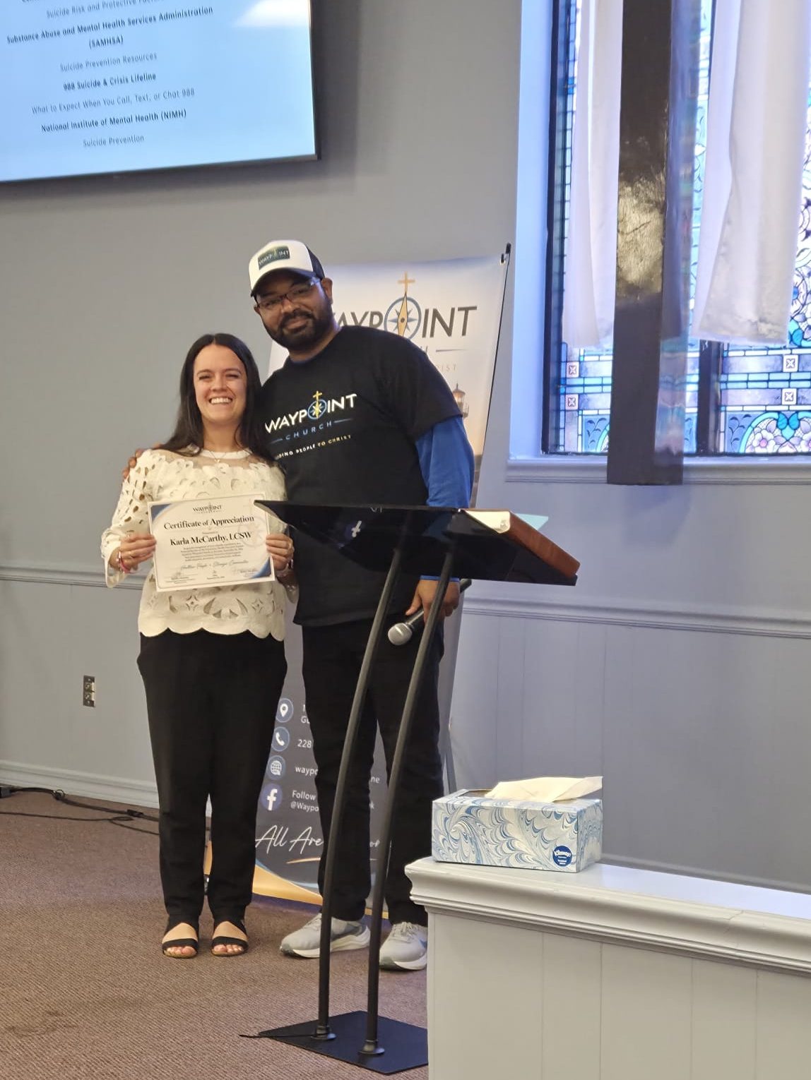 Pastor Kelsey presenting a certificate of appreciation
